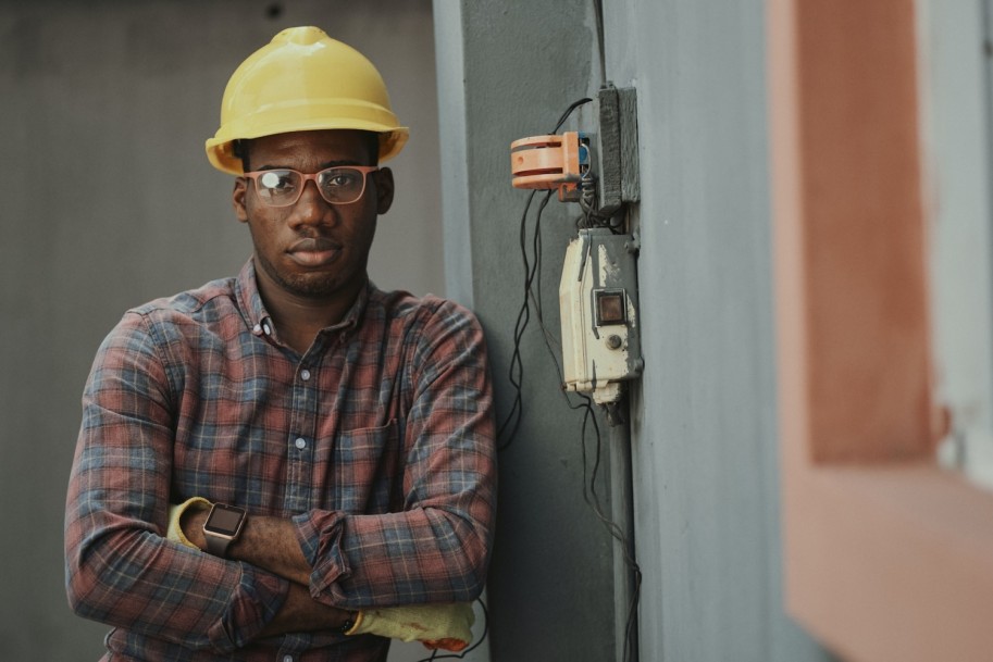 Confident civil engineering wearing a hardhat and eye goggles.