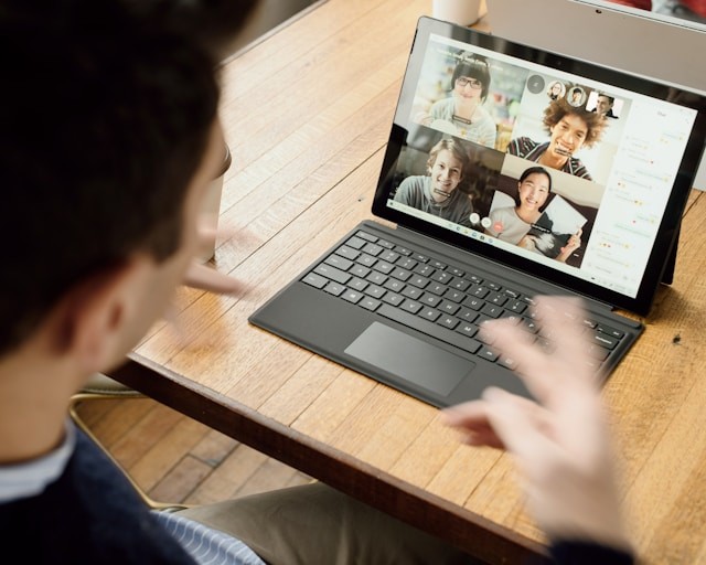 A photo showing a man having a remote meeting