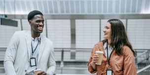 Photo of two employees chitchatting while having a coffee 