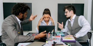 A photo of workers looking confused while talking