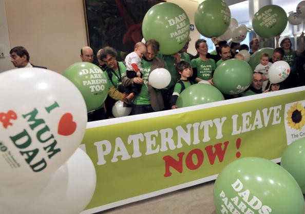 Members of the MEP greens party demonstrate in support of fully paid paternity leave 