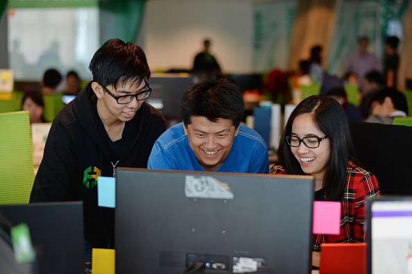 Satisfied Employees Doing Their Work At A Computer