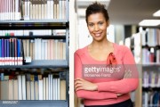 Librarian leaning on shelves in library 