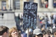 A protester holds a placard during a rally in Trafalgar Square in central London May 1, 2013. Credit: Reuters/Toby Melville