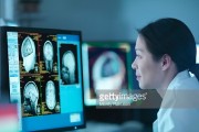 Scientist looking at 3D rendered graphic scans from Magnetic Resonance Imaging (MRI) scanner, close up 