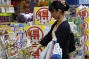 A woman looks at goods outside a drugstore in Tokyo June 28, 2013. Credit: Reuters/Yuya Shino