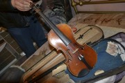 A Bulgarian police official shows a violin, which the Interior Ministry says carries the sign of Antonio Stradivarius, in this handout photo released on February 28, 2013. British detectives are inves