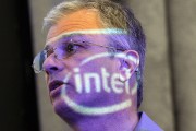 The Intel logo is projected on the face of Intel Executive Vice President Dadi Perlmutter 