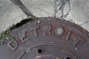 'Detroit' is seen on the top of an iron man-hole cover on a street in Detroit, Michigan July 27, 2013. 