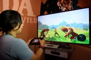 Gamers try out the new to play the new video game 'The Legend of Zelda: Breath of the Wild' in the Nintendo booth durin E3 2016.