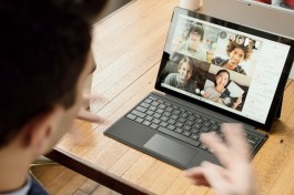 A photo showing a man having a remote meeting