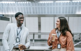 Photo of two employees chitchatting while having a coffee 