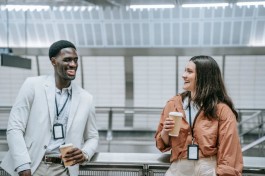 Photo of two employees chitchatting while having a coffee 