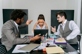 A photo of workers looking confused while talking